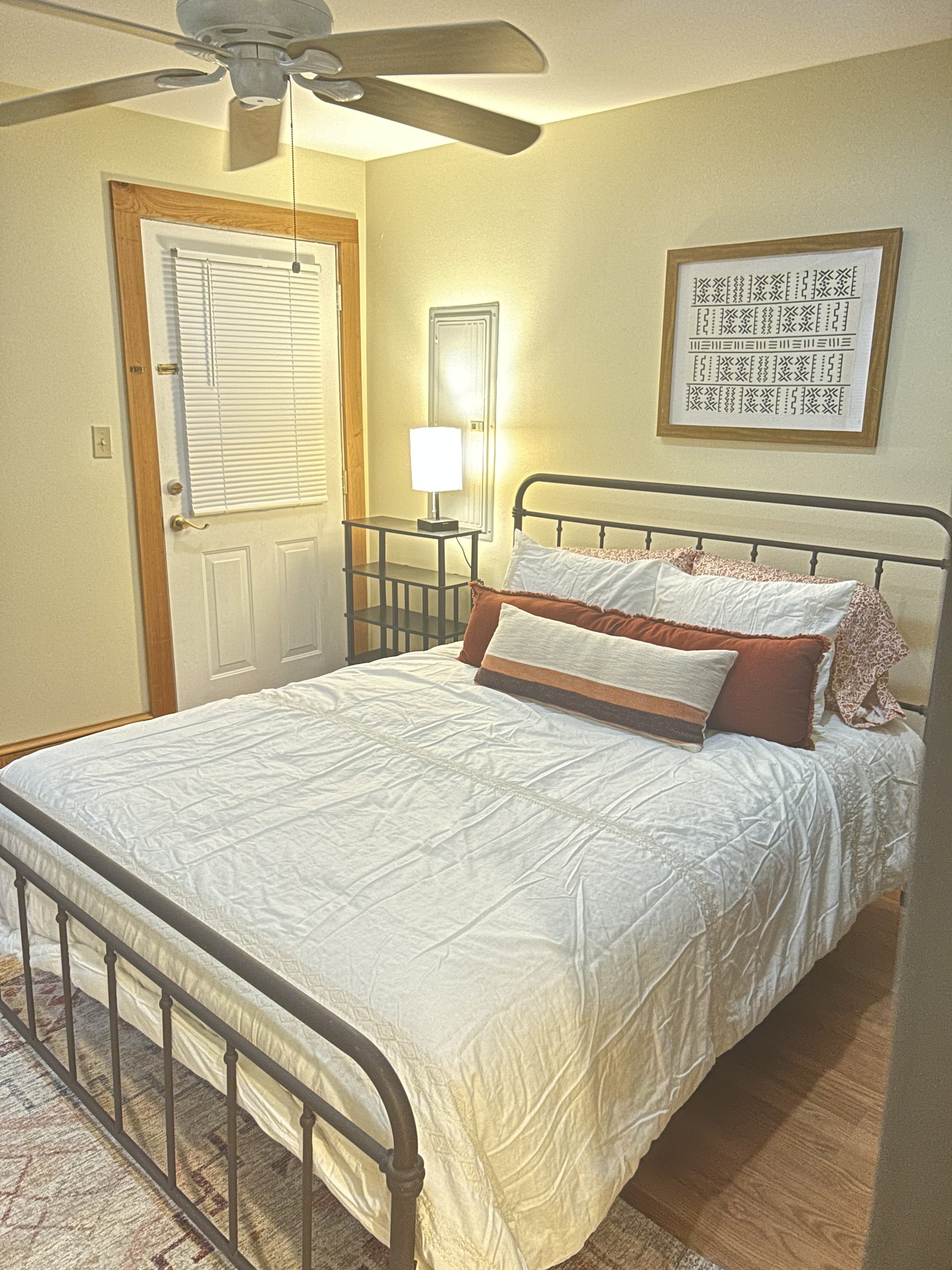 Cottage bedroom with queen bed and warm lighting