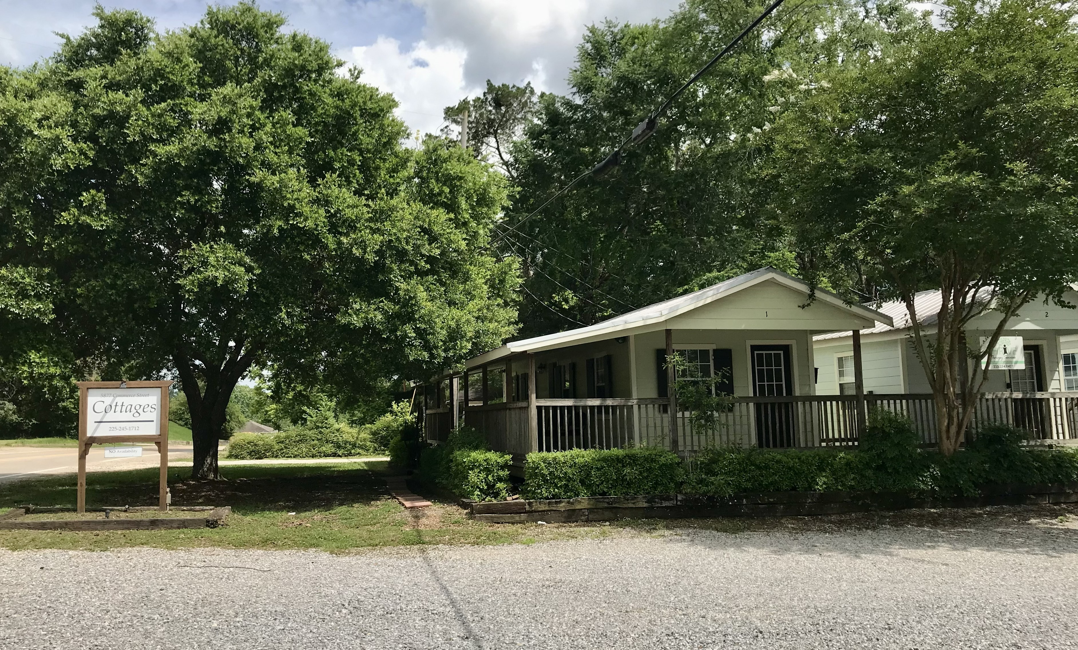 Cottages on Commerce entrance with signage and front porch